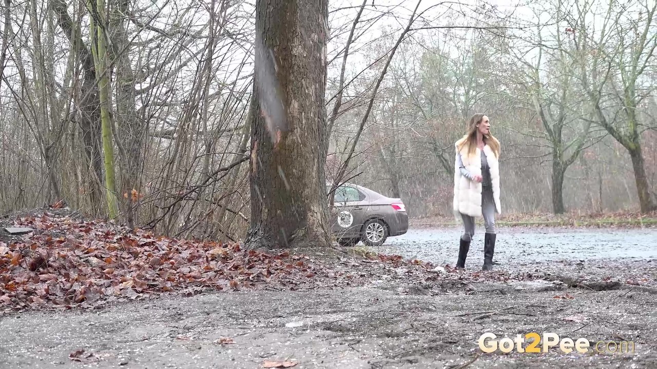 Solo girl Cynthia Vellons takes a piss in a gravel driveway on a wet day porn photo #424881846