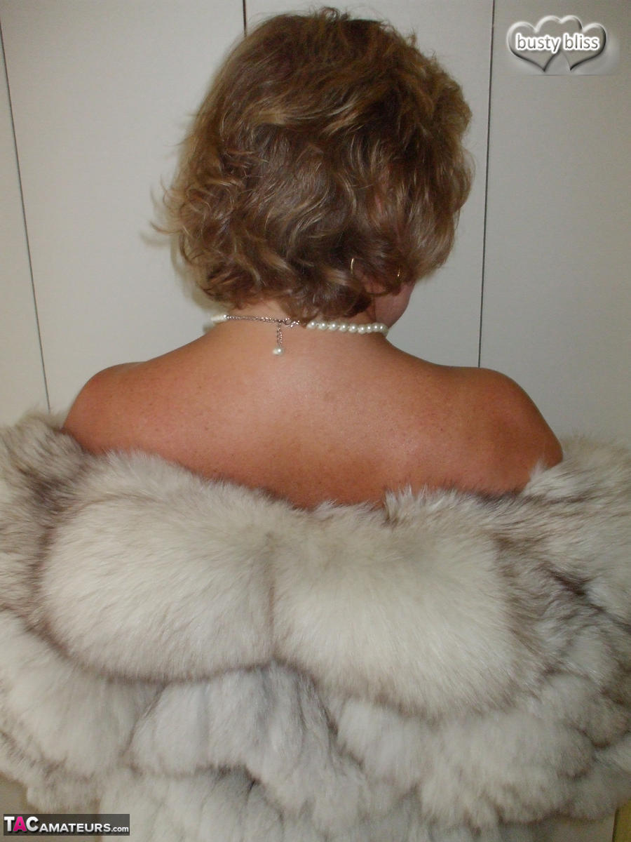 Mature amateur Busty Bliss exposes her tan lined tits while wearing a fur coat porn photo #429077058