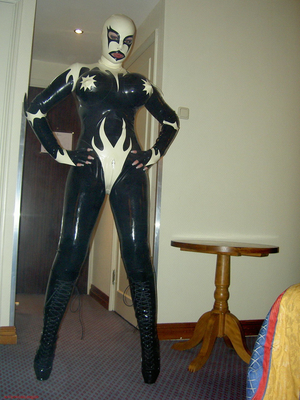 Fetish model Darkwing Zero poses on a hotel room bed in latex clothing porn photo #426050016