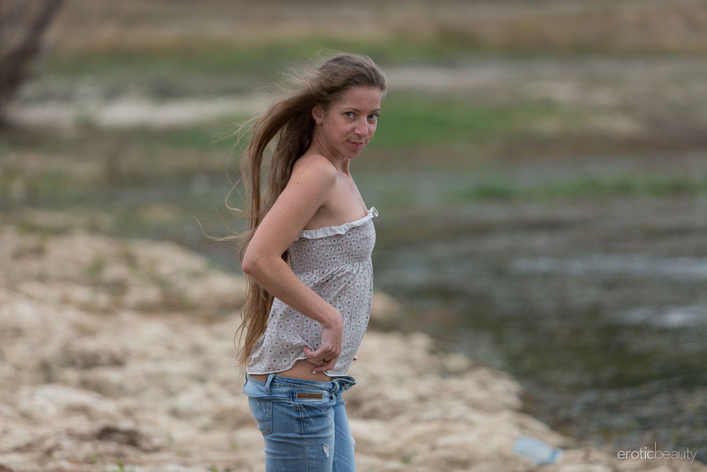 Teen model Mika A works free of faded blue jeans to get naked on a beach porn photo #425082162