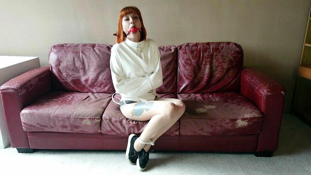 Natural redhead sports a ball gag while restrained with a straitjacket porn photo #425674757