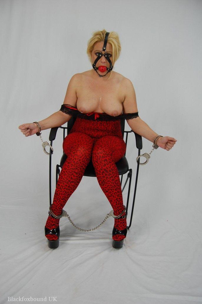 Thin blonde hair is chained and made to perform a ball gag until the cock is ready.