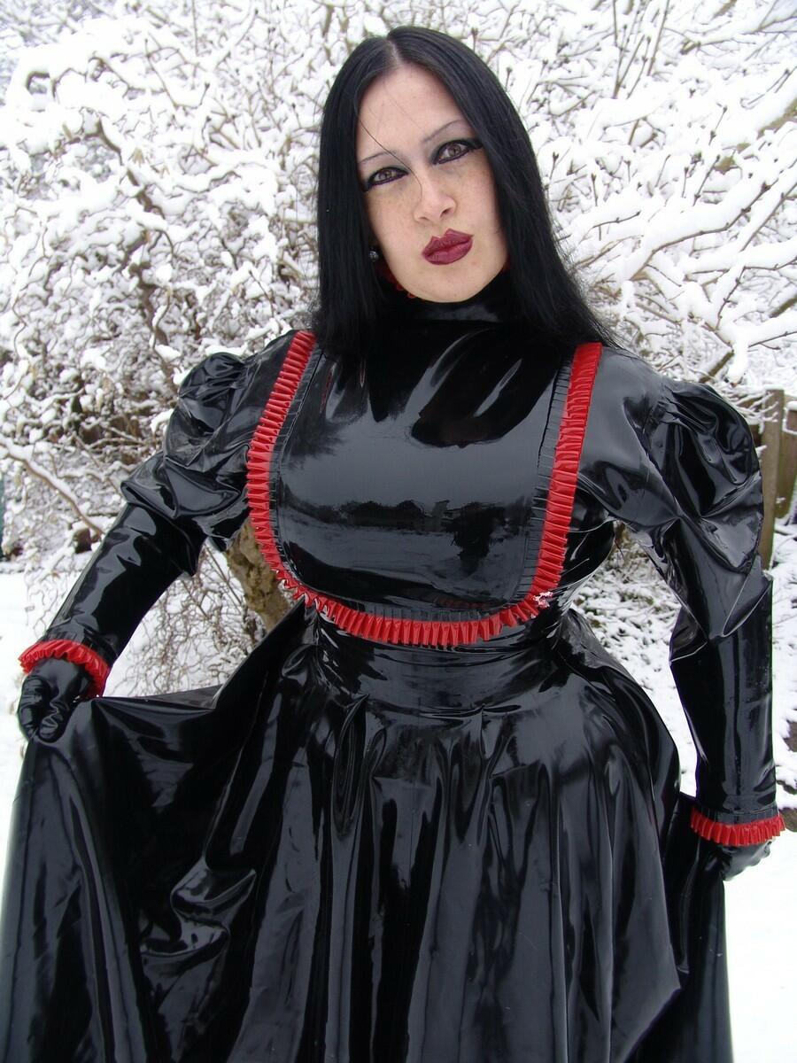 Goth woman Lady Angelina models a black latex dress on snow-covered ground porno foto #423838486