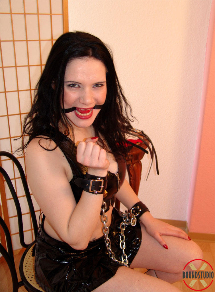 Brunette chick Akasha sticks a ball gag in her mouth during a SFW solo shoot porn photo #425096974