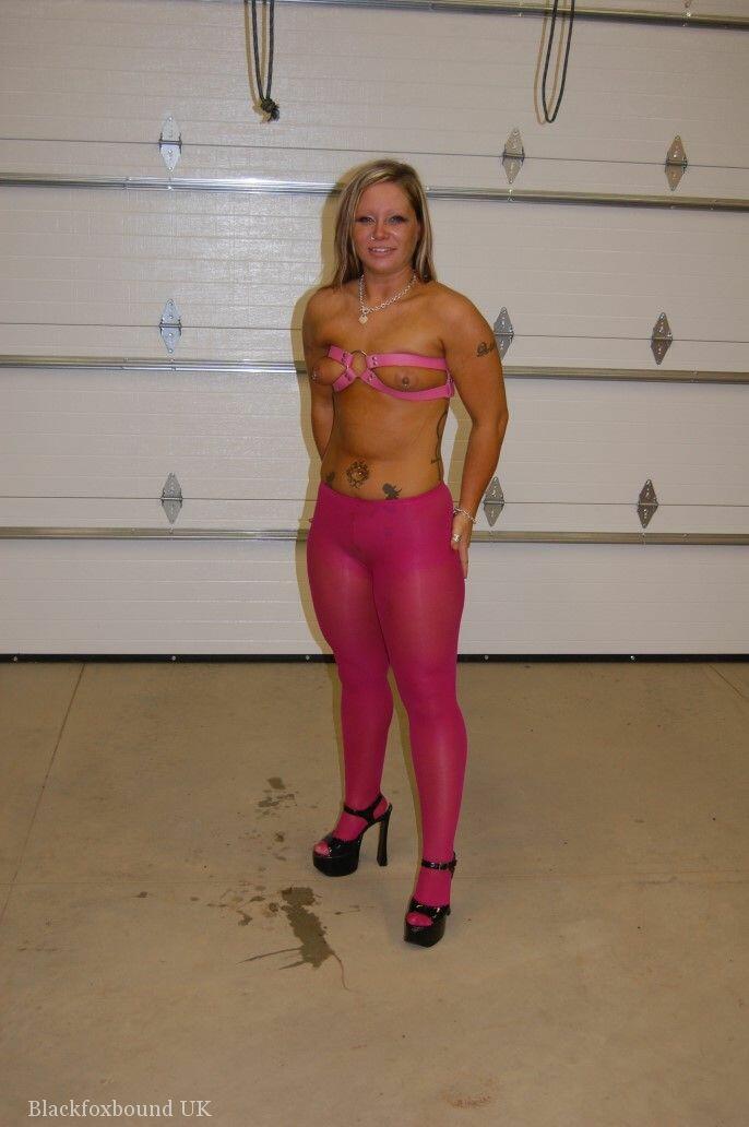 A dirty blonde wears pink pantyhose and heels as she performs a ball gag.