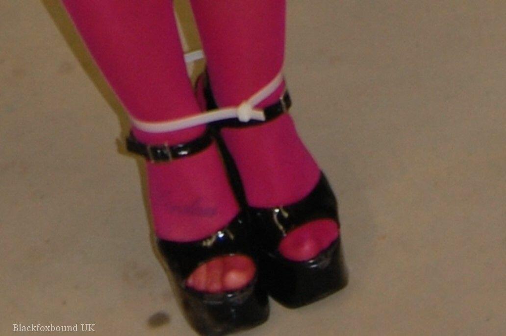 In pink pantyhose and high heels, the dirty blonde performs a ball gag.