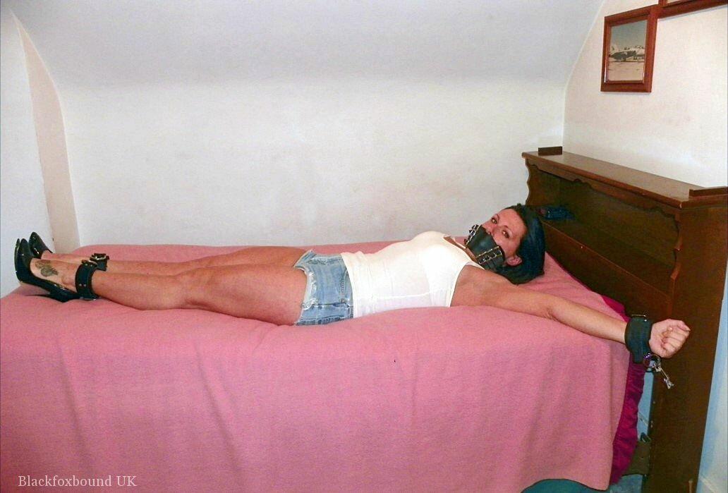 Denim cutoffs and a solo girl are being concealed in her cleaved hands on the bed.