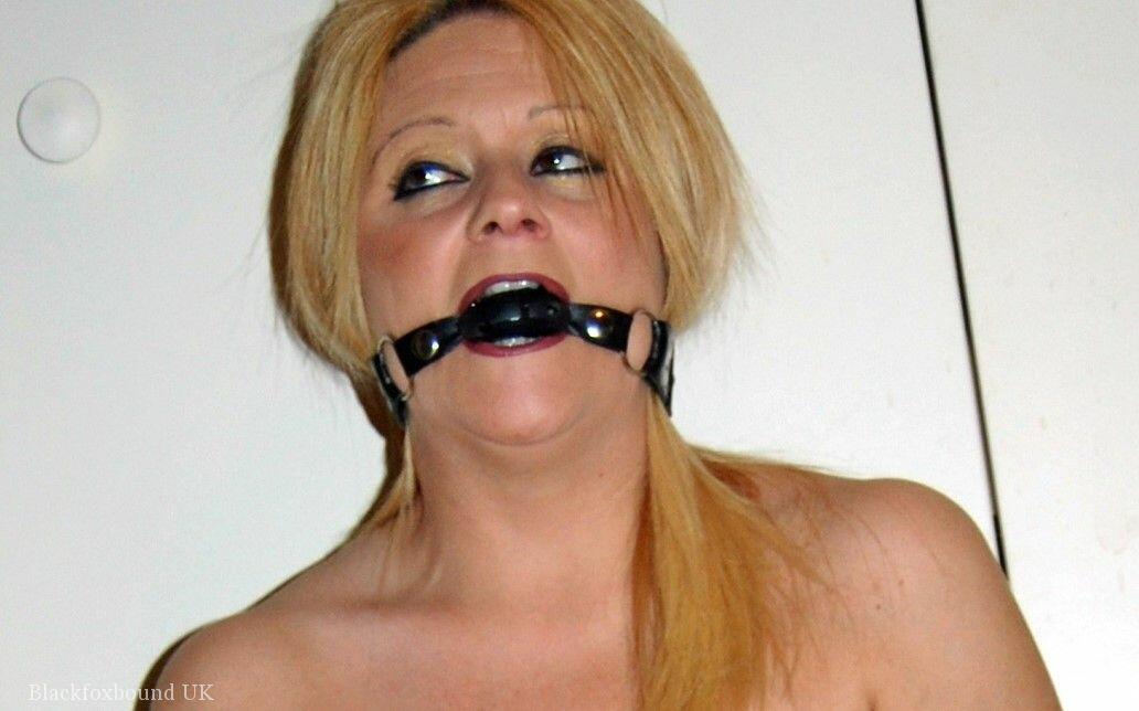Natural blonde Adrienna loses a ball gag for a brief moment to give head porn photo #428121098