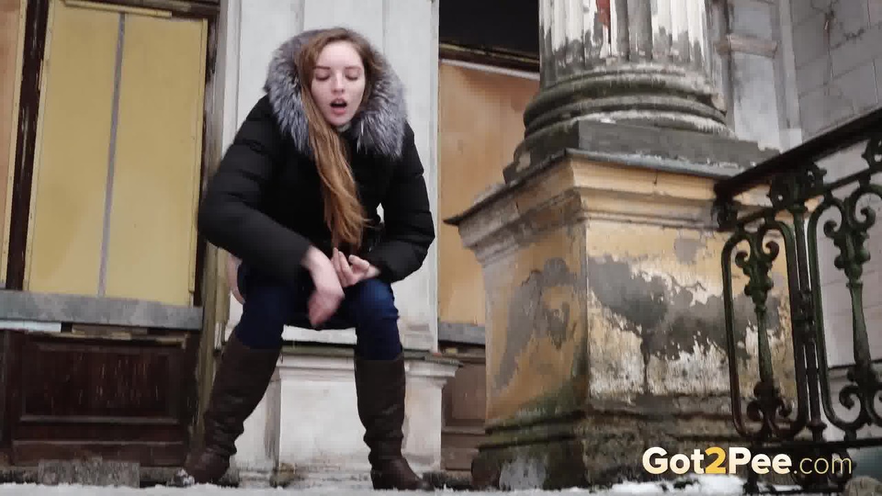 Clothed redhead Vika squats for a pee on the snow-covered steps of a church porno foto #428437822