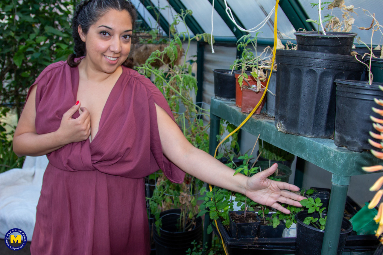 Chubby lady lets her hair down while disrobing to masturbate in a greenhouse порно фото #428835603