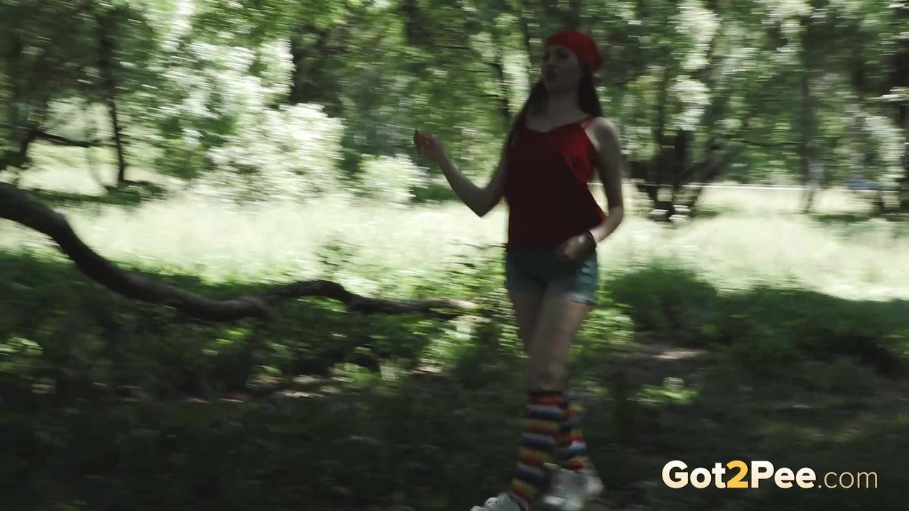 Young blonde Larisa takes a pee behind a tree in multi-coloured knee socks porn photo #426396344