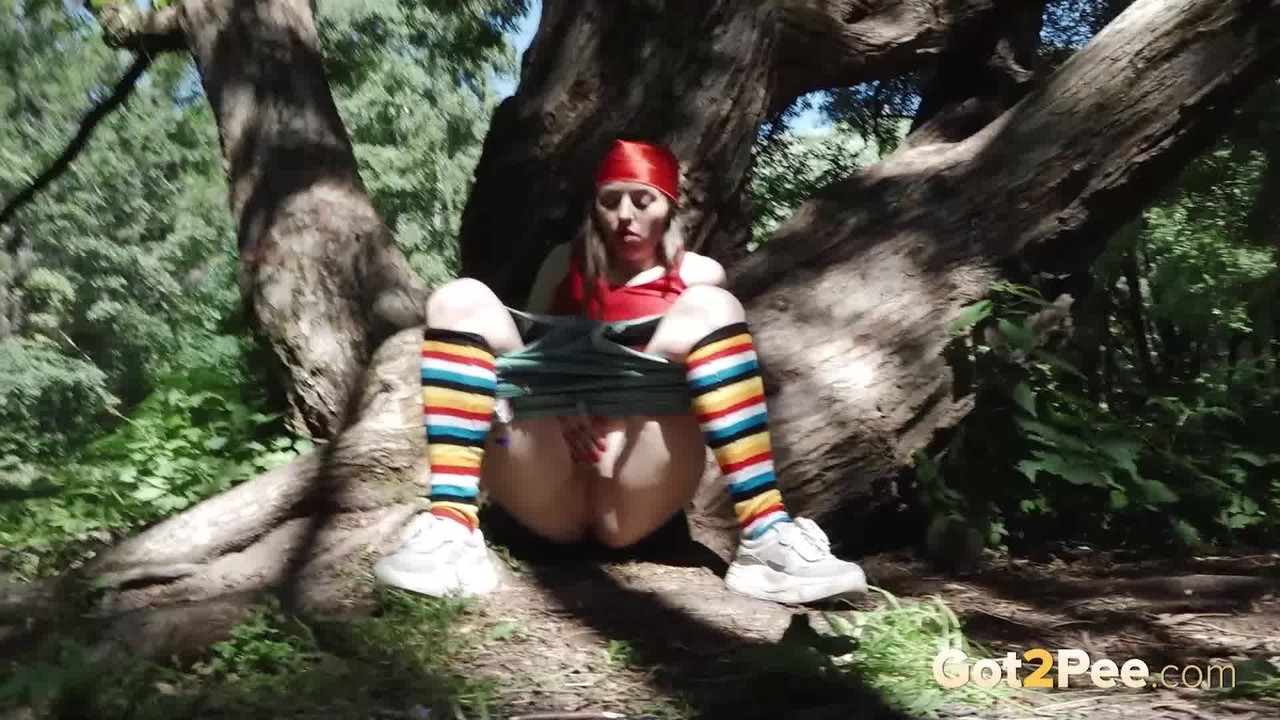 Young blonde Larisa takes a pee behind a tree in multi-coloured knee socks foto porno #426396364