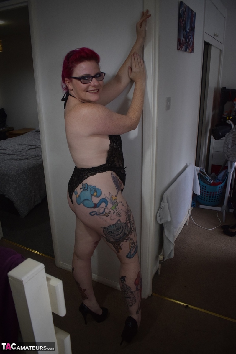 Tattooed amateur Mollie Foxxx models black lingerie with her glasses on