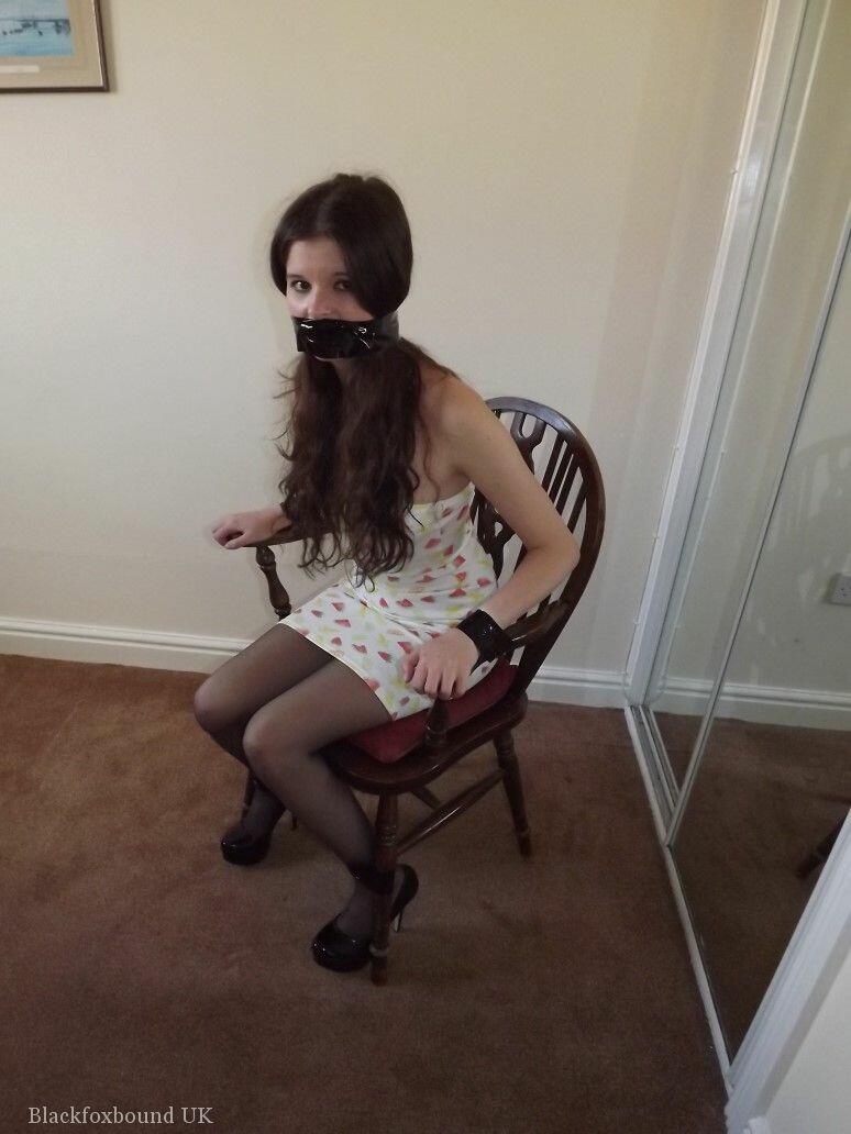 Clothed girl Tamara looks in a mirror while gagged and restrained to a chair porno foto #423821455