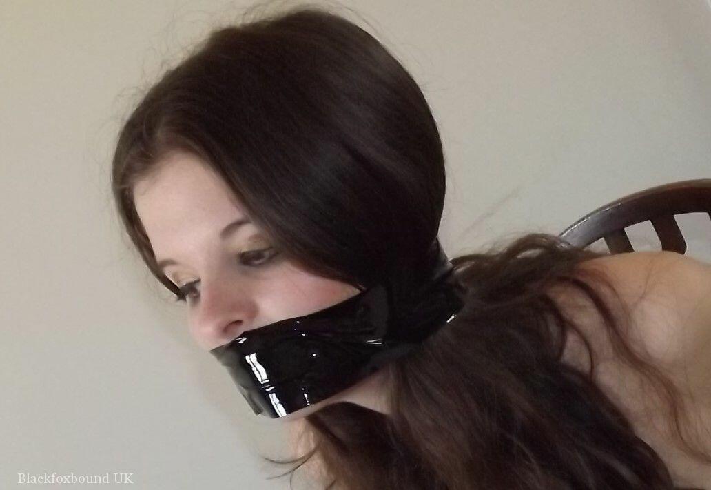 Clothed girl Tamara looks in a mirror while gagged and restrained to a chair porn photo #423821463