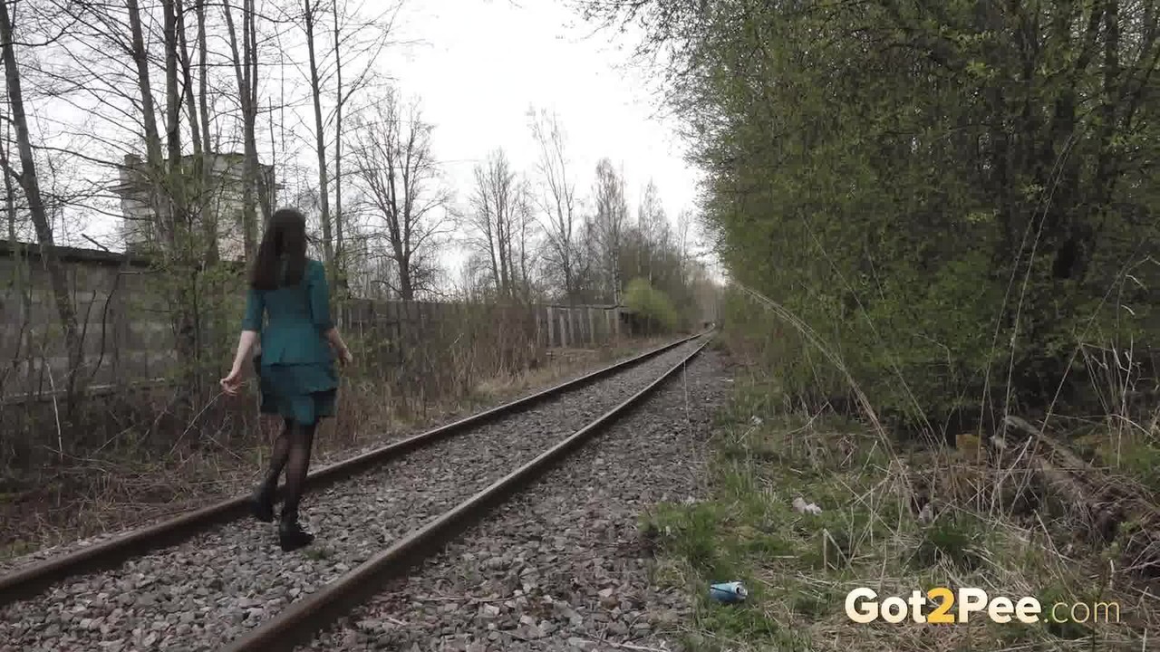 Brunette girl Lara pees on concrete blocks while walking railway tracks foto porno #425778402