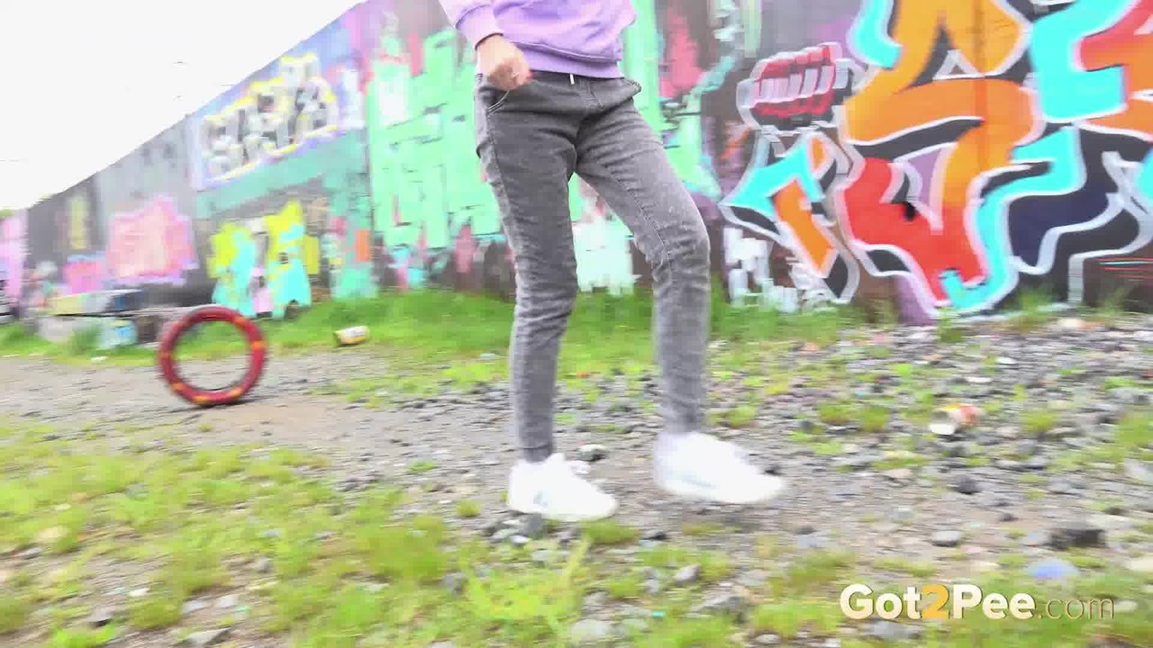 Solo girl Mistica pulls down her jeans to take a piss on a gravelly footpath порно фото #426400414