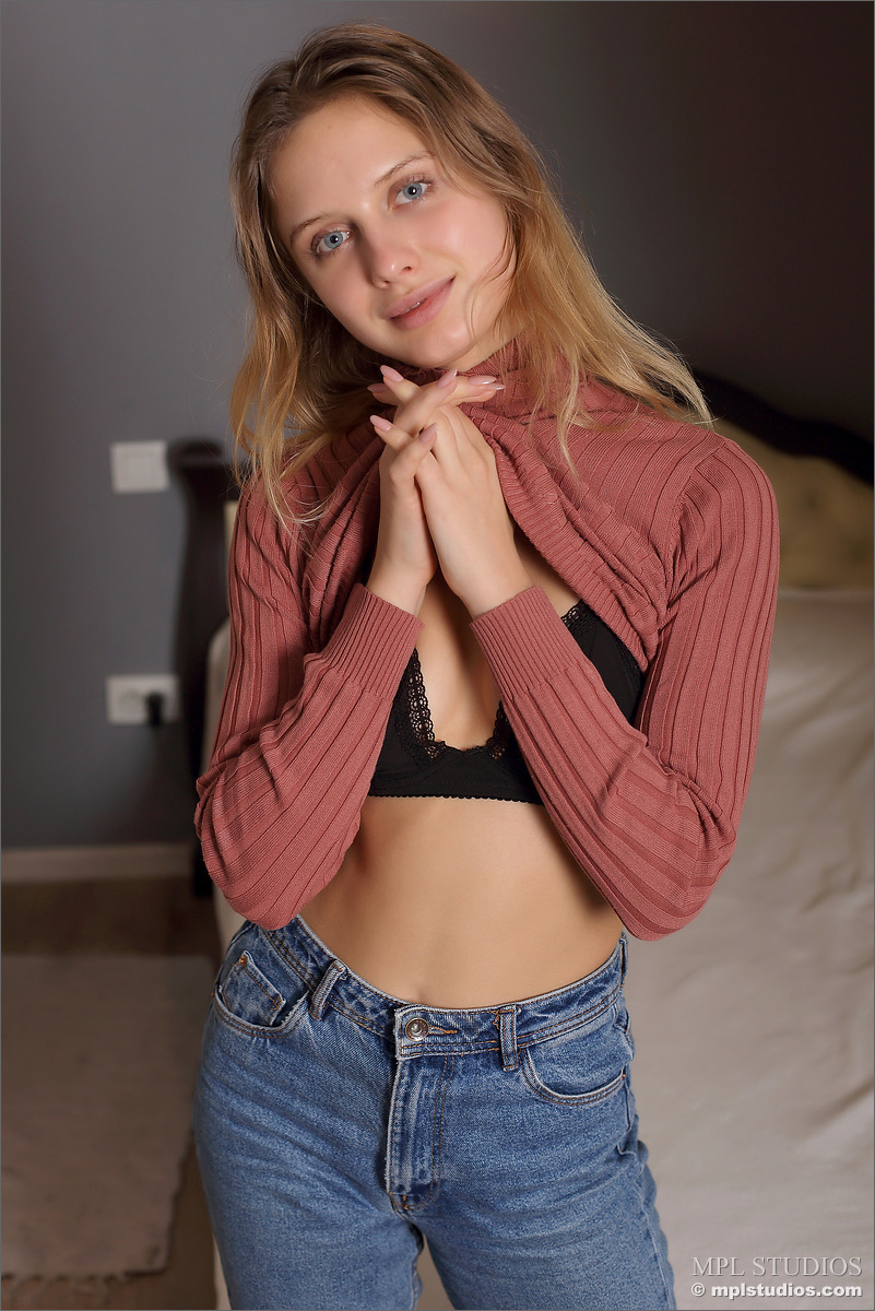 Barefoot beauty removes a long-sleeved shirt and jeans to model naked porno foto #428972901