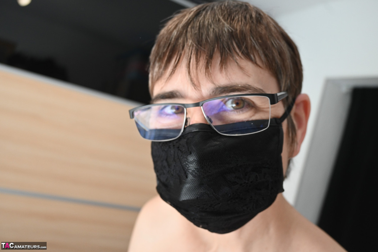 Naked amateur with short hair dons a face mask before beginning to dress porn photo #428342666