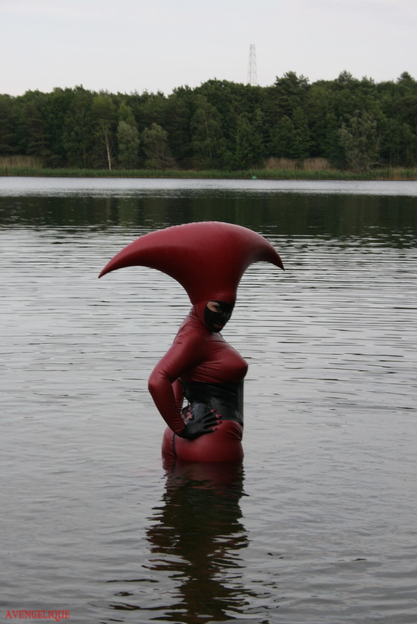 Fetish model Avengelique wades into a body of water in a rubber costume porn photo #427876385
