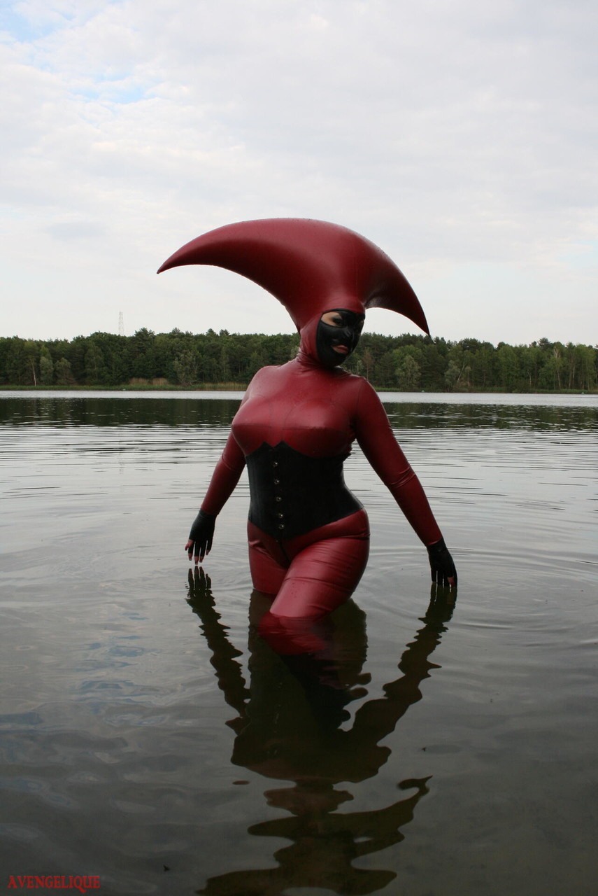 Fetish model Avengelique wades into a body of water in a rubber costume porn photo #427876398