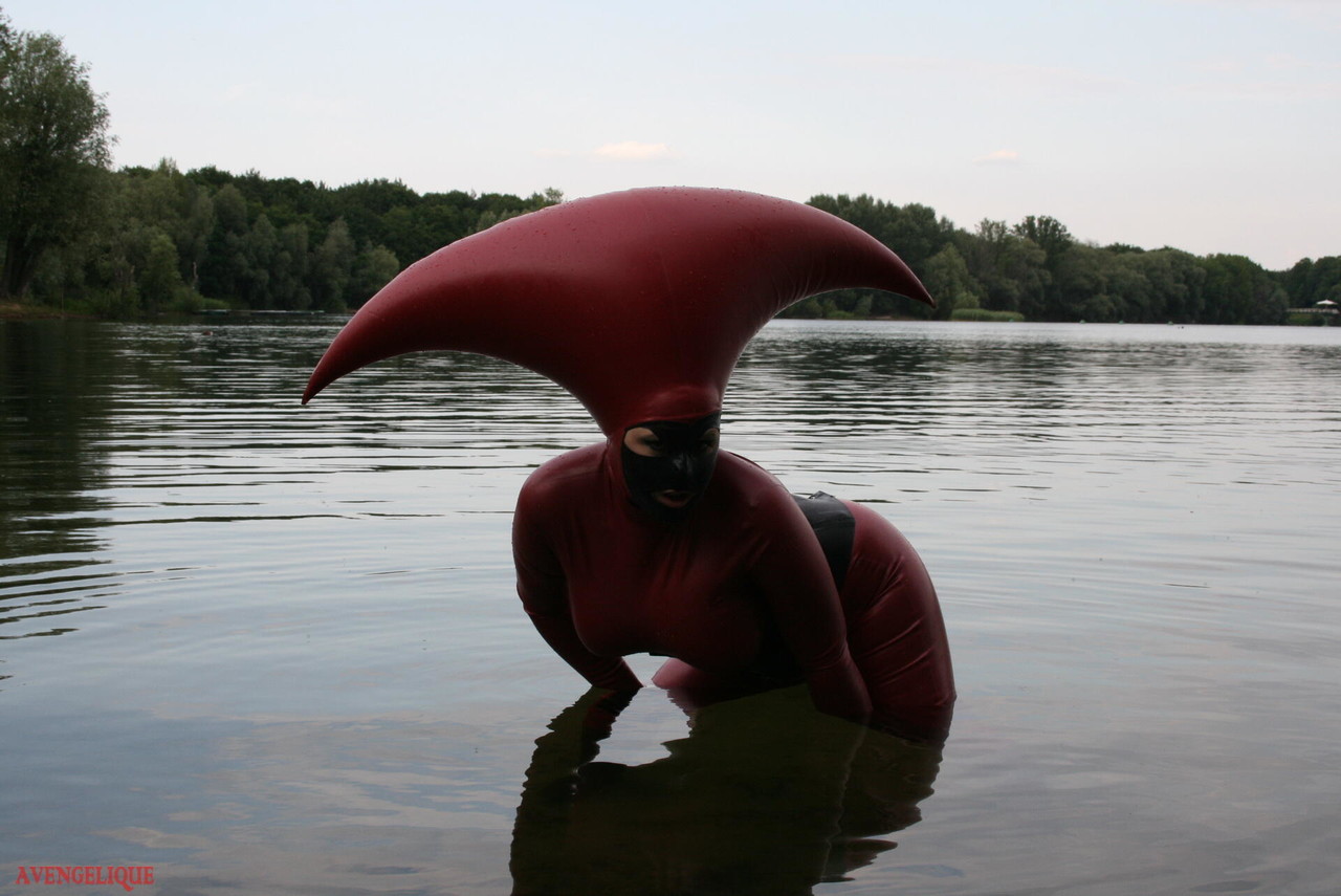 Fetish model Avengelique wades into a body of water in a rubber costume 포르노 사진 #427876400