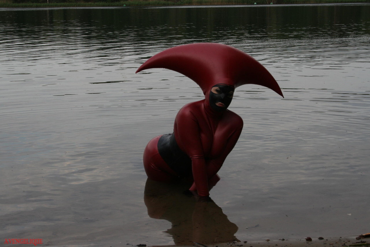 Fetish model Avengelique wades into a body of water in a rubber costume foto porno #427876410
