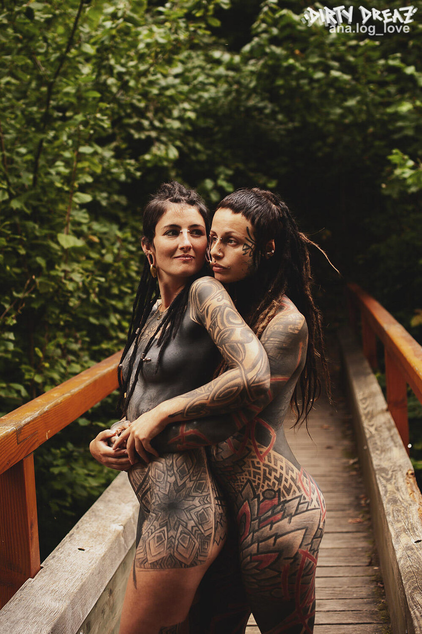 Heavily tattooed lesbians hold each other while totally naked on a bridge porn photo #423468076