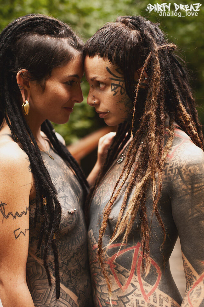 Heavily tattooed lesbians hold each other while totally naked on a bridge porn photo #423468078