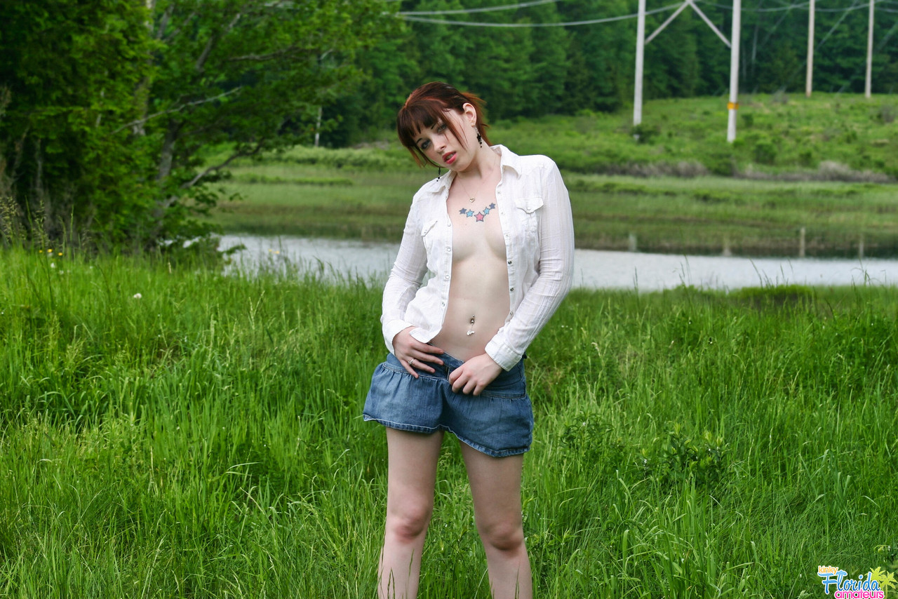 Amateur girl with red hair Barbie A exposes her tits while in a grassy field photo porno #425404386