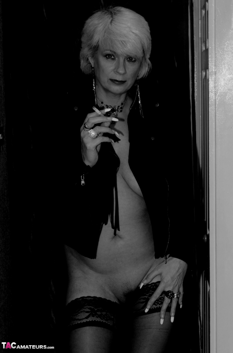 Older blonde lights a cigarette while showing her bare breasts and pussy foto pornográfica #424106441