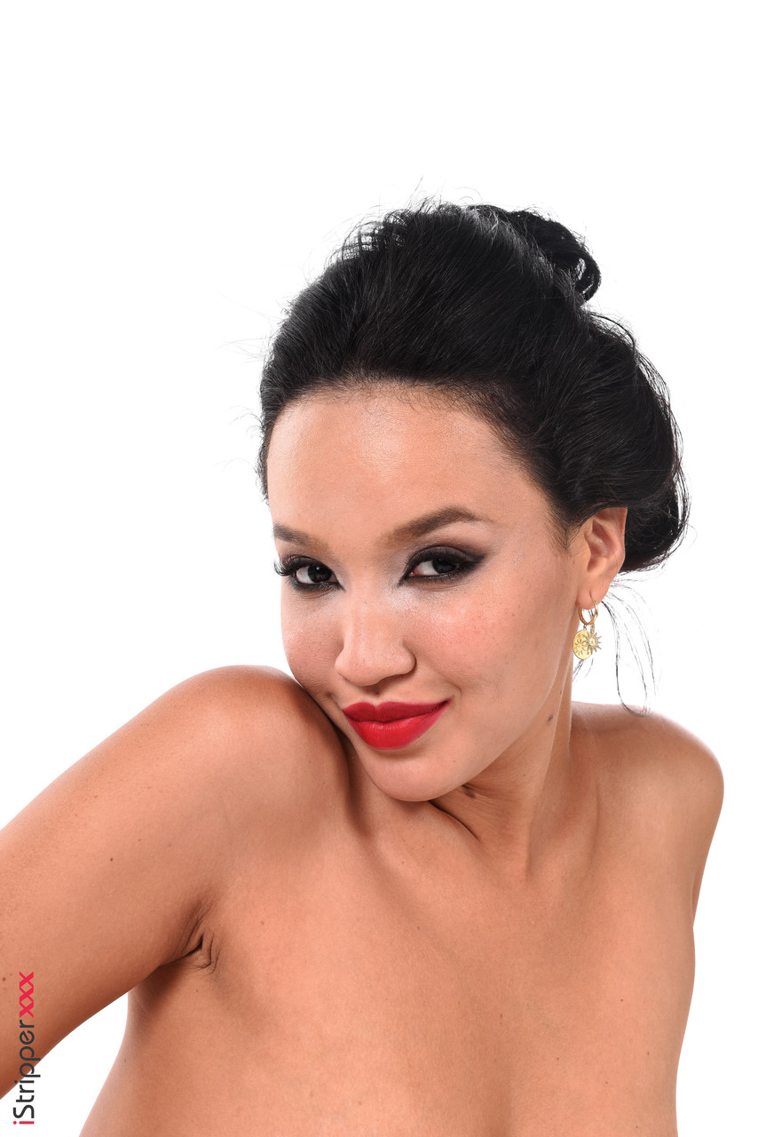 Asian girl of sexiness, Asia Vargas shows off her good looks by donning a black dress and holding onto something like a toy.