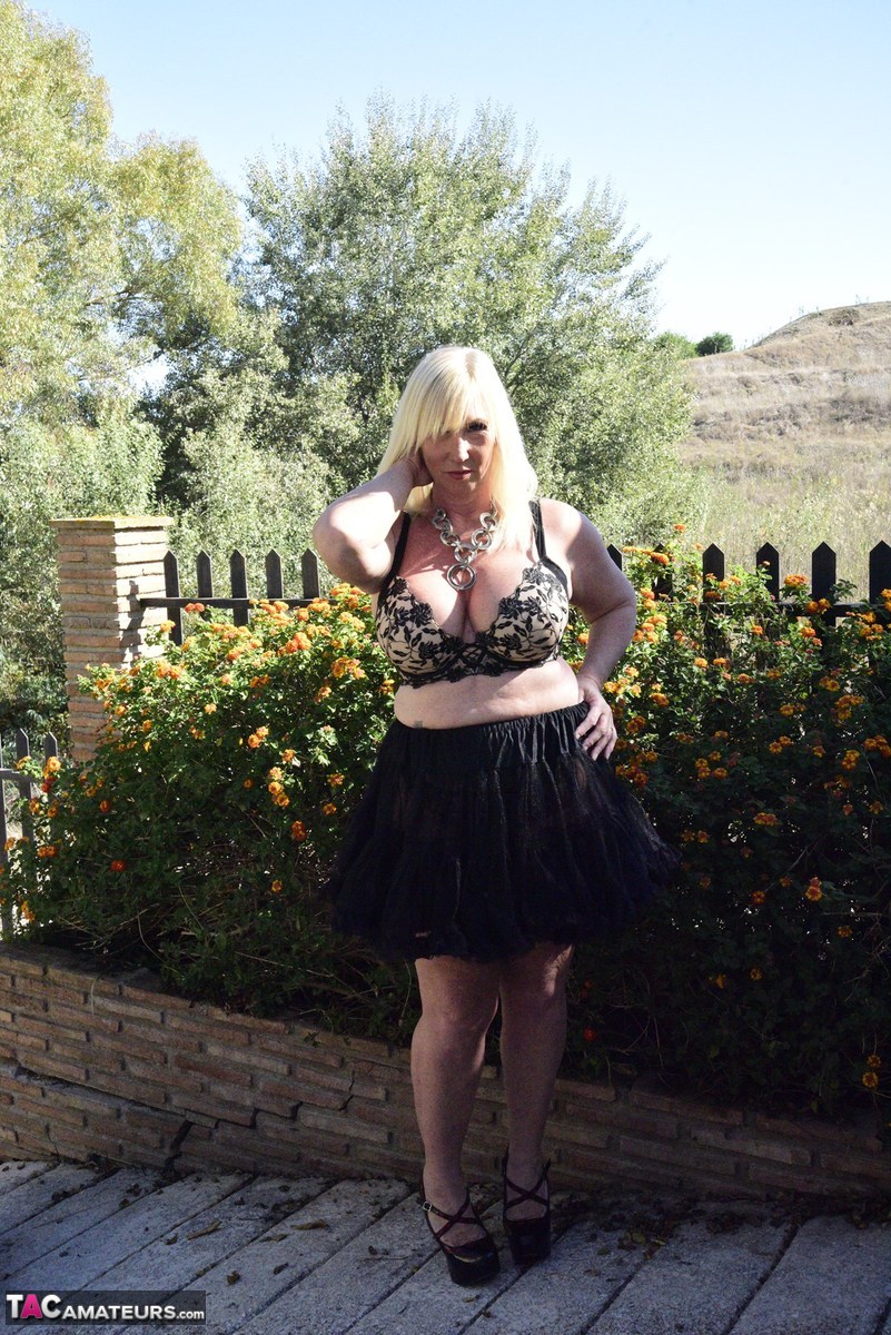 Blonde granny Melody exposes her overweight body in an English garden porn photo #428814734