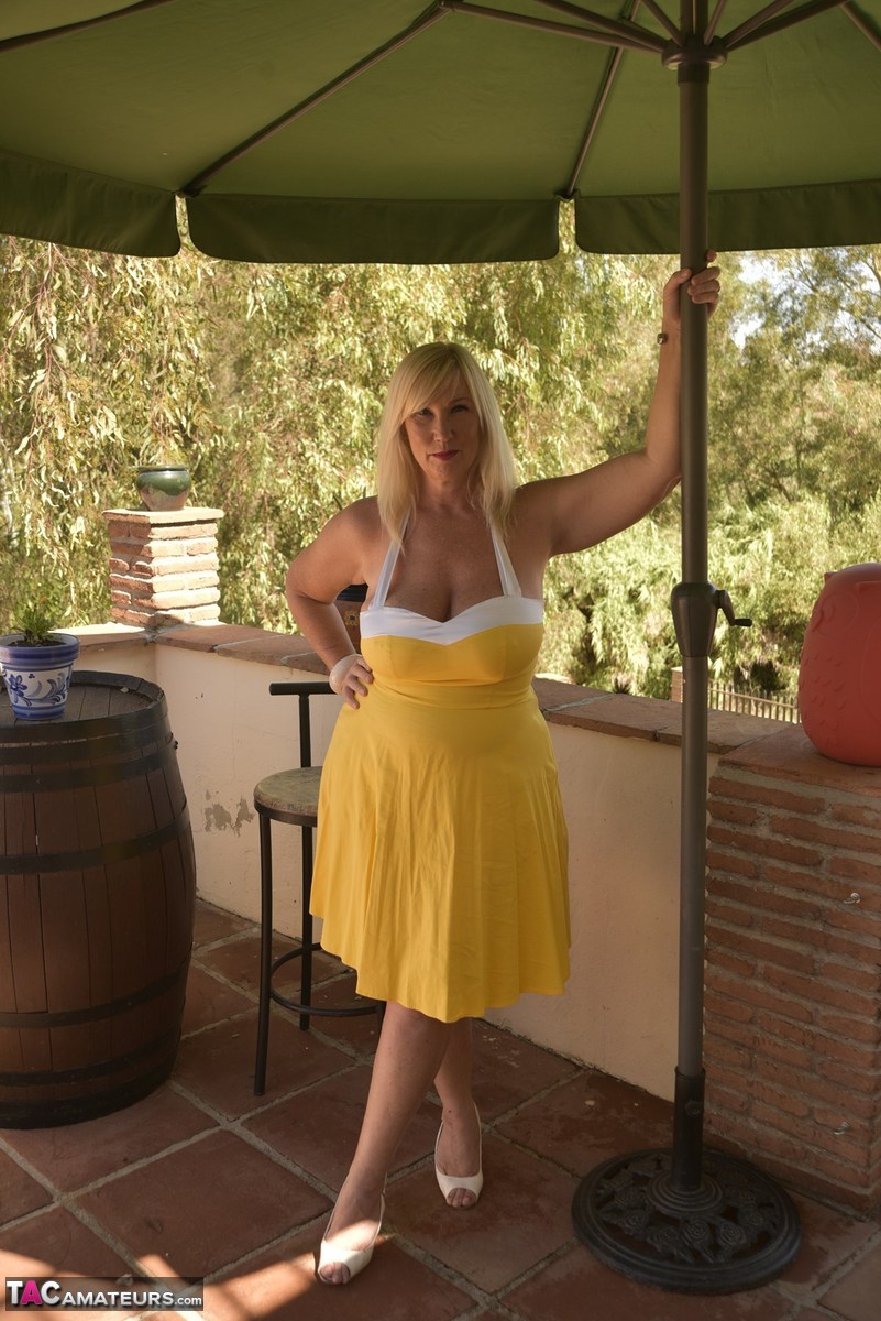 Overweight blonde Melody works free of a pretty dress while on a balcony porn photo #424351996
