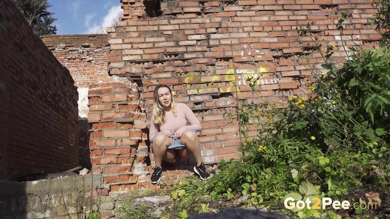 White girl ducks behind an old building to take an urgent piss porn photo #425289287