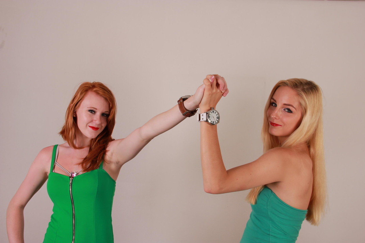 Lesbian girls Eva and Amanda display their Oozoo watches while fully clothed porn photo #425113340