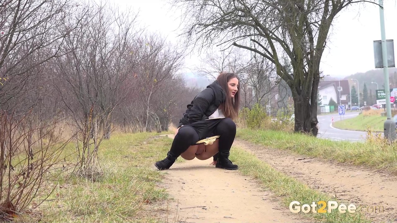 Nicolette Noir squats for a badly needed pee while walking on a dirt path porno foto #426315453