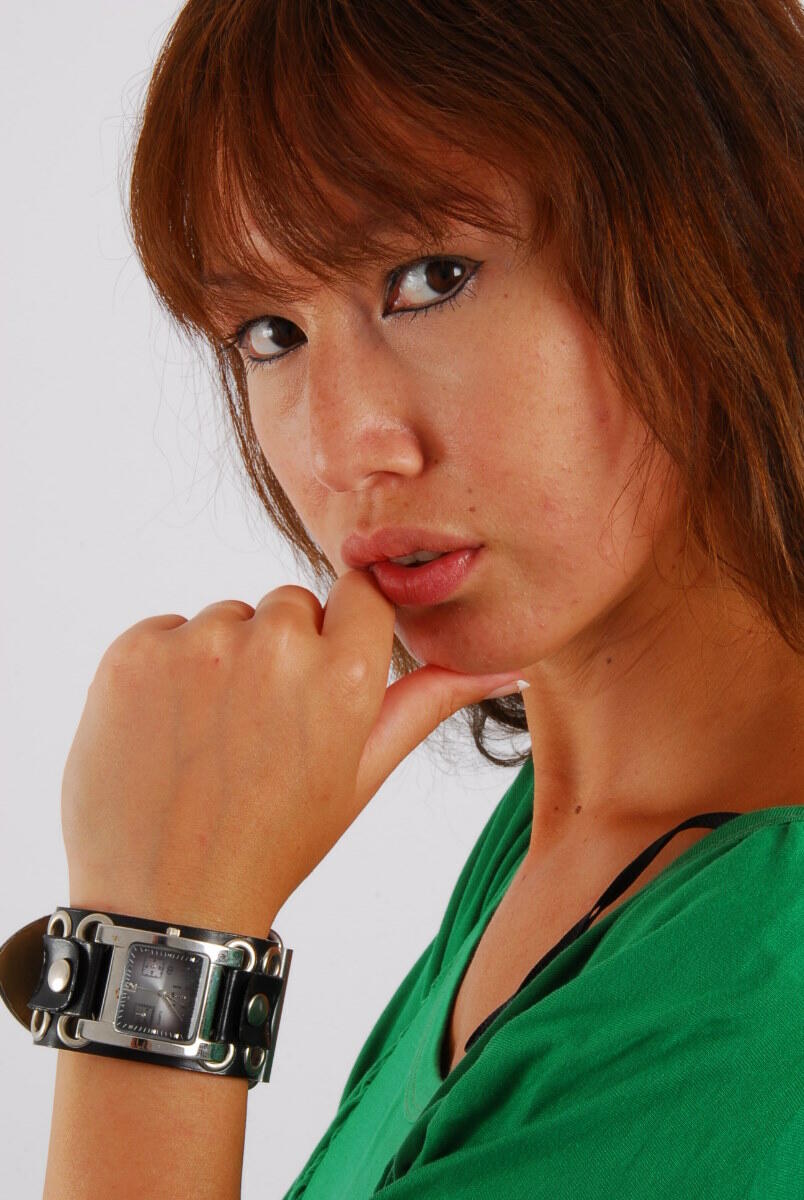 In SFW action, Evita, an Asian girl with red hair, models a Guess style cuff watch.