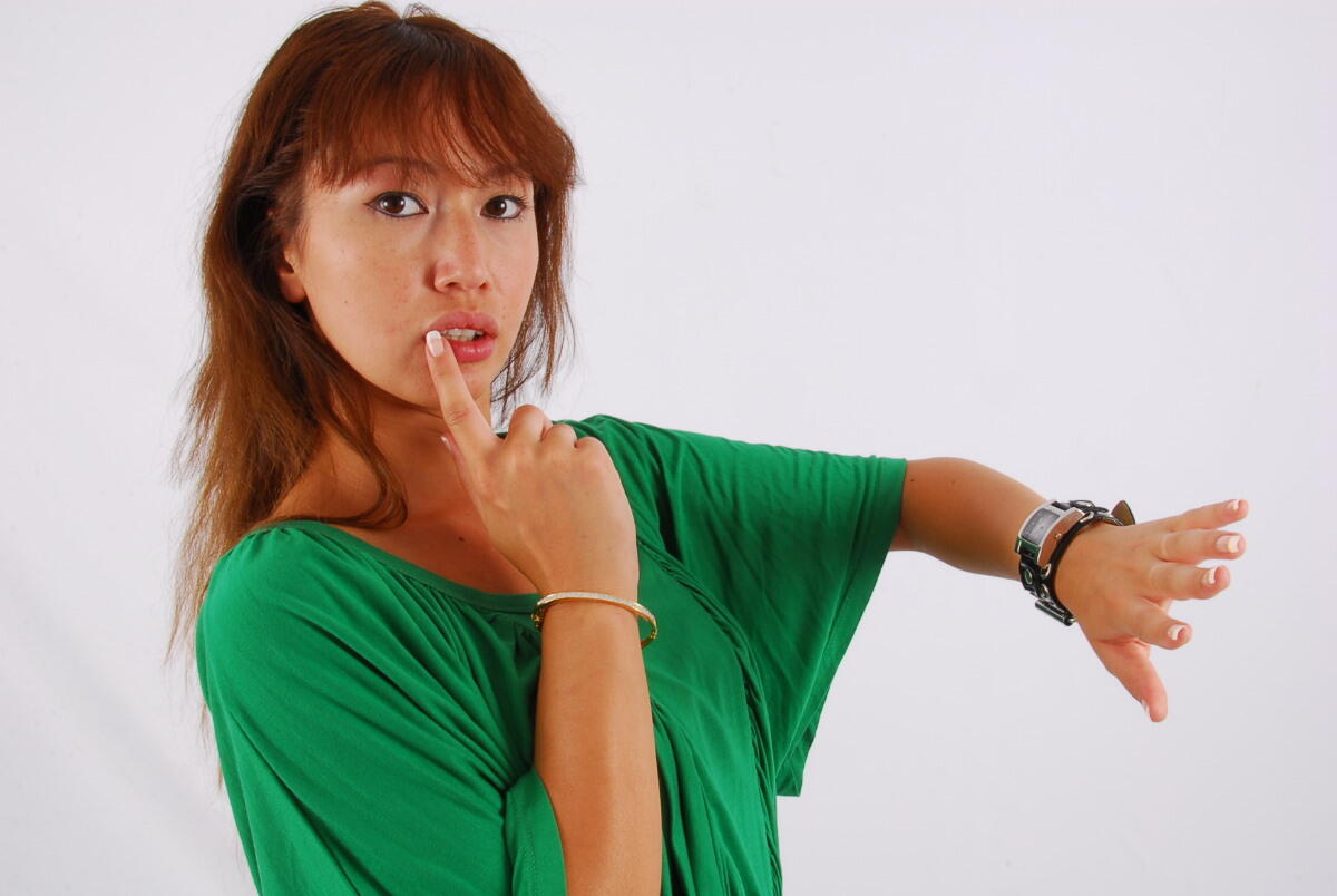 Evita, a red-headed Asian girl, displays a Guess style cuff watch while participating in SFW.
