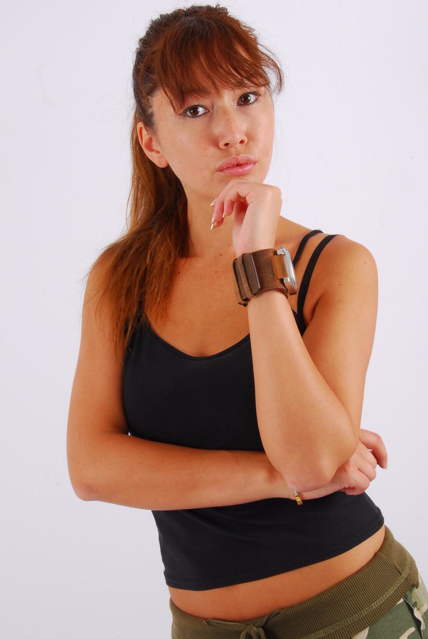 Non-nude action: Asian redhead Evita wears a huge watch with the big OOZOO cuff watch.