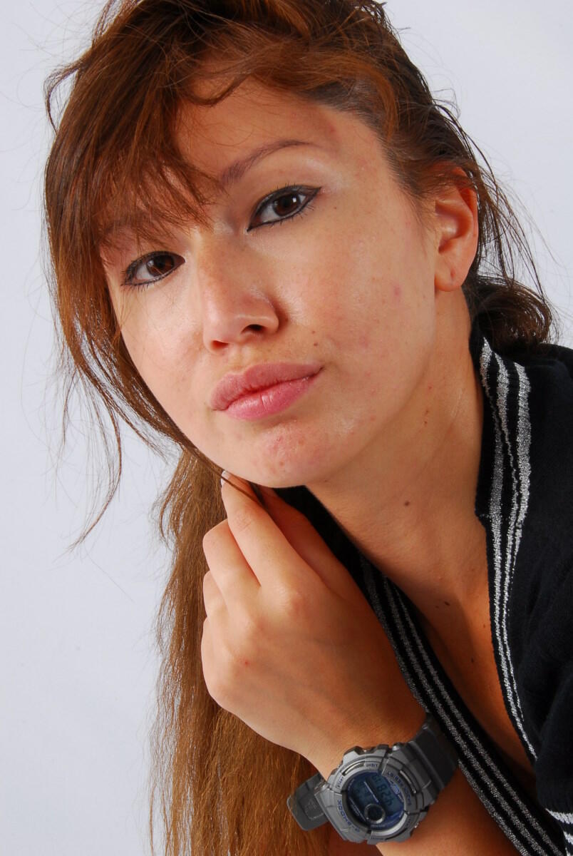 Evita, a red-haired Asian, sports her grey G-Shock watch while fully clothed.