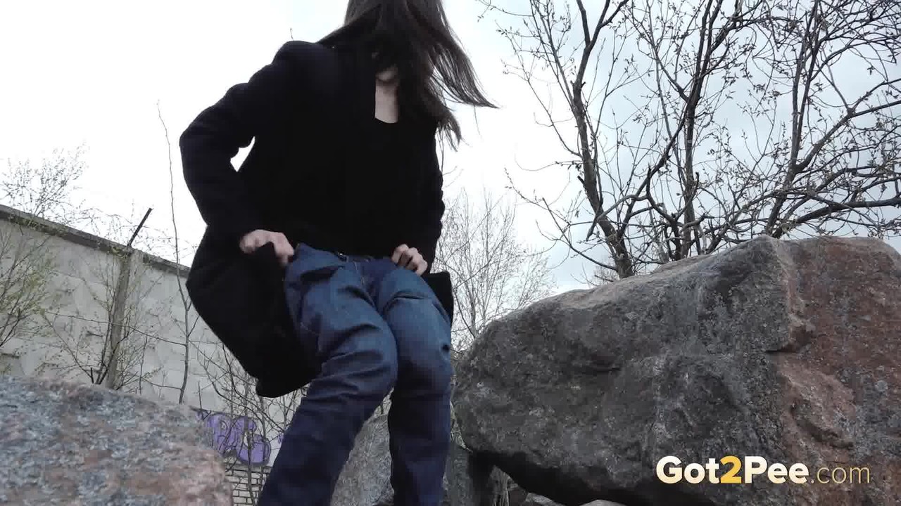 Brunette chick Lara Fox pulls down her jeans to take a piss upon boulders porn photo #425136581