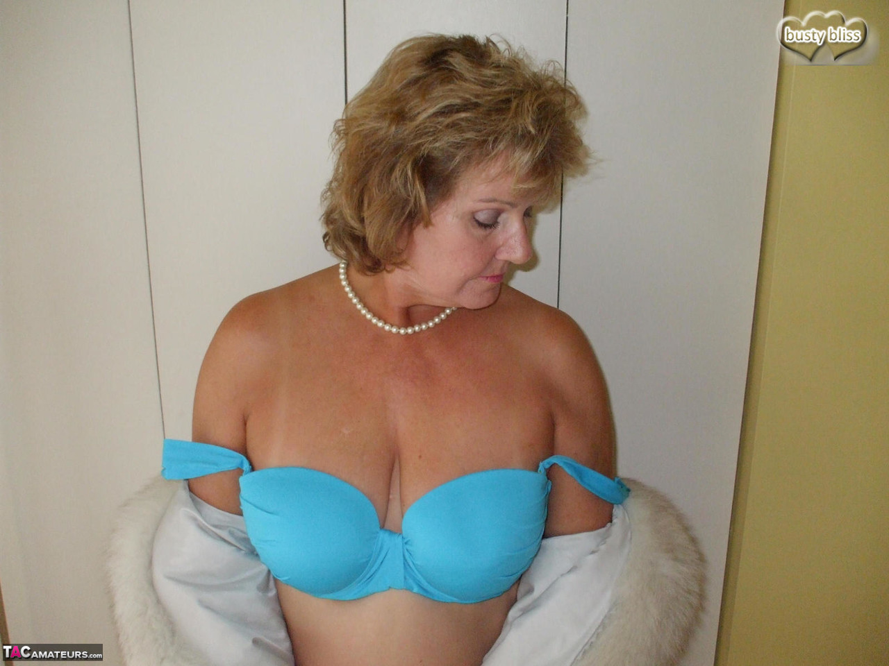 Solo granny Busty Bliss looses her tan lined tits from a fur coat porn photo #428156576