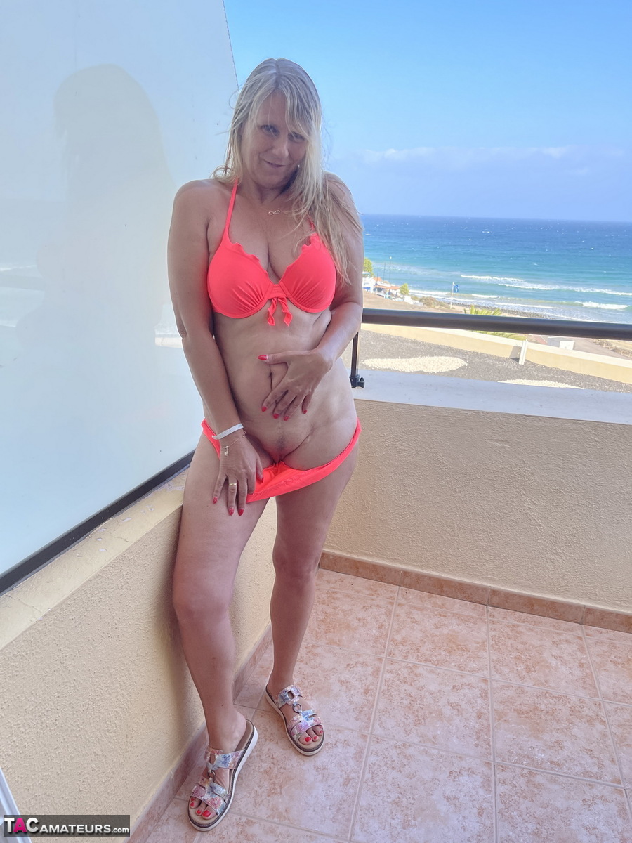 Middle-aged blonde Sweet Susi strips naked on a condo balcony porn photo #424634961