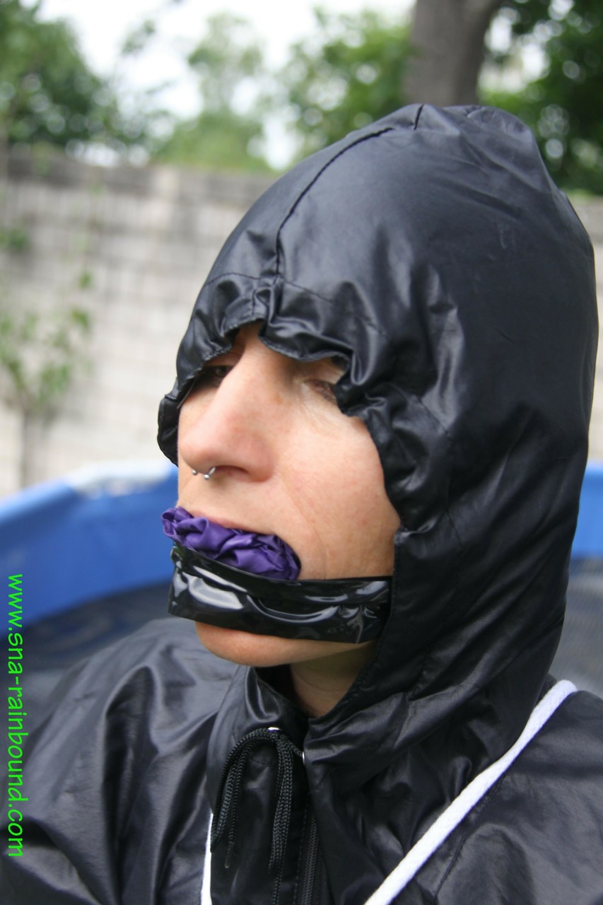 Amateur woman Sandra is gagged and tied to a pool in a raincoat photo porno #425389813