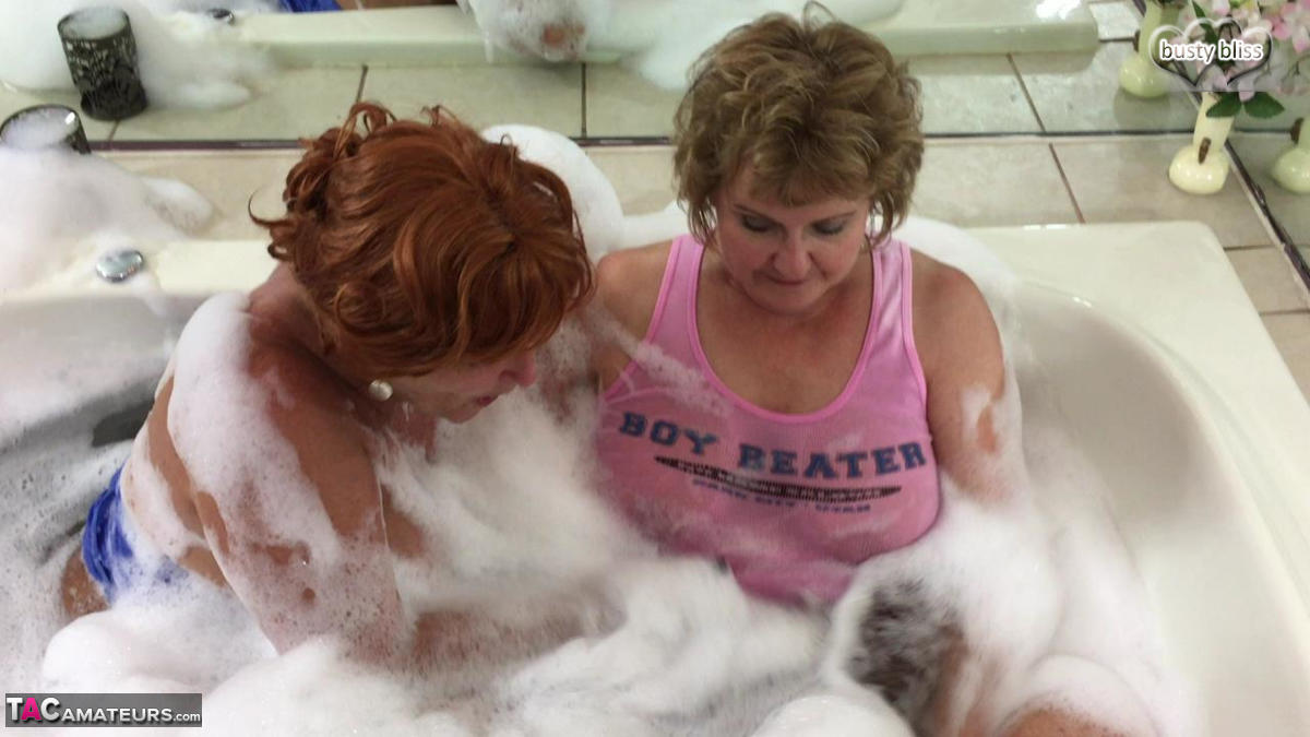 Busty Bliss, an older self-confessed amateur, engages in sexual activity with women while bathing in bubbles.