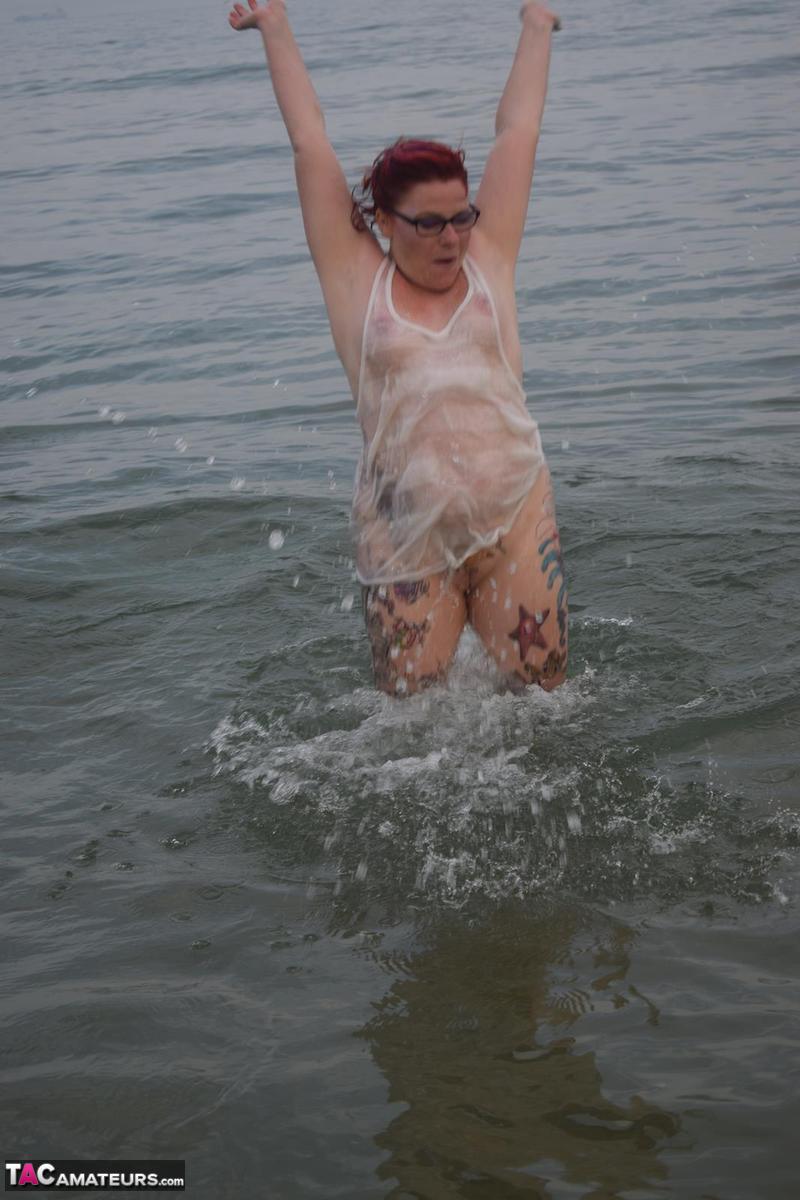 Mature redhead Mollie Foxxx wets her tattooed body in the ocean porno fotky #428338784