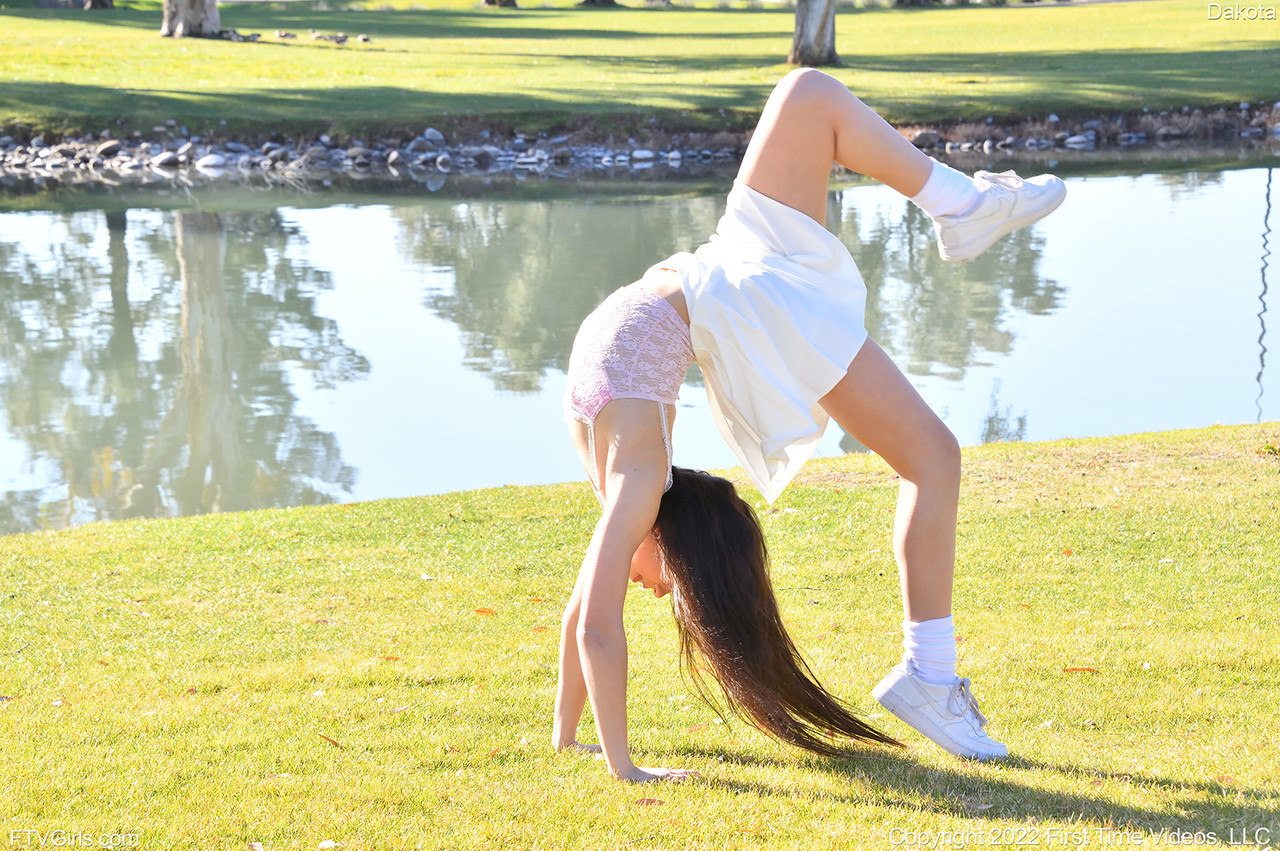 Brunette amateur Dakota does a cartwheel in a park before getting naked porn photo #423846321