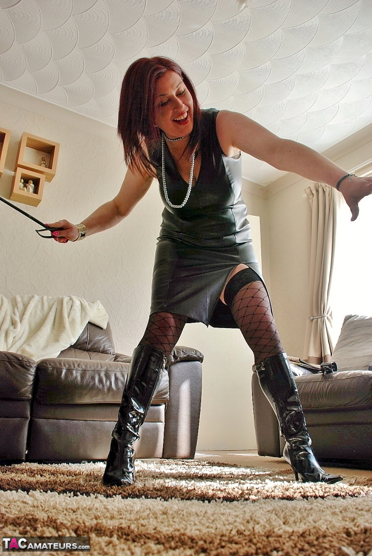 British redhead Juicey Janey hikes up a leather dress while wielding a flogger foto porno #422759650