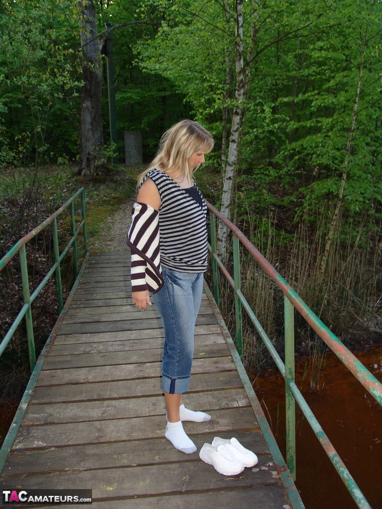 Middle-aged blonde Sweet Susi gets bare naked during a walk thru a nature park porn photo #425252112
